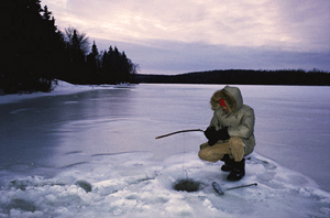 Ice fishing in the Canadian Rockies of Western Canada.